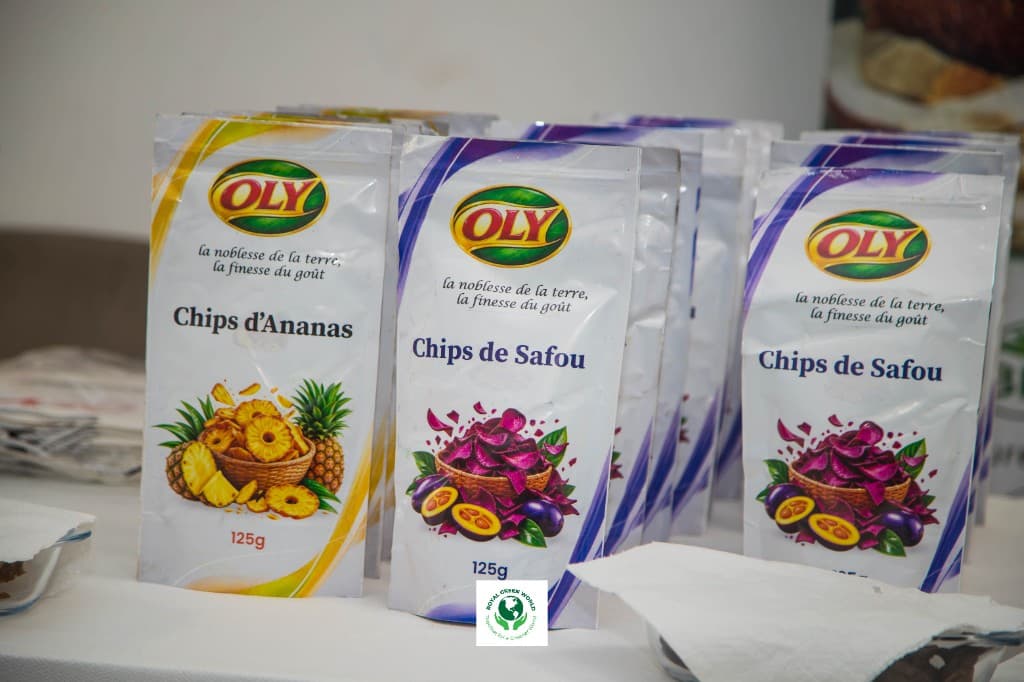 Packs of OLY pineapple chips and safou chips on a display table