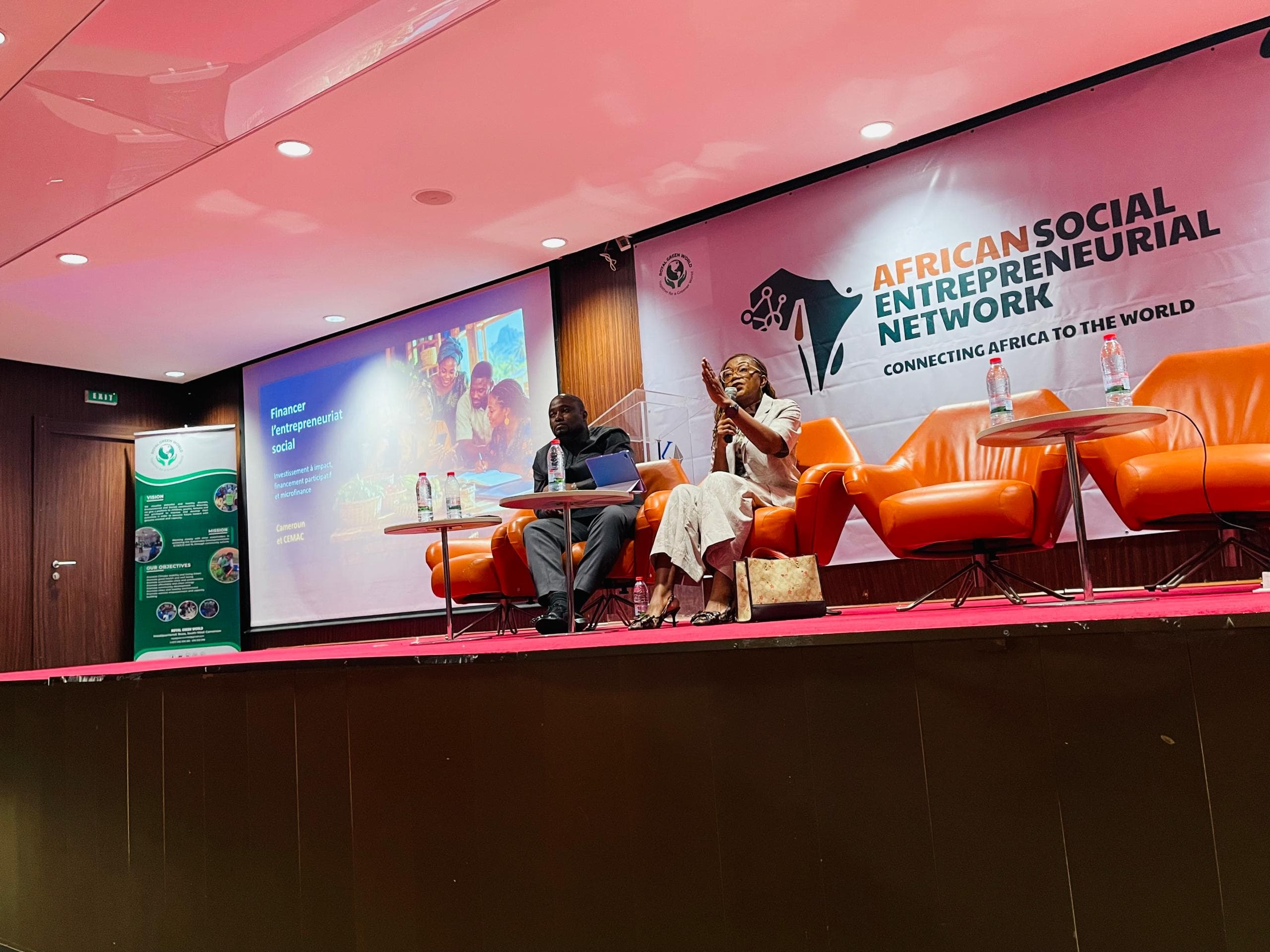 Panel discussion on financing social entrepreneurship with ASEN branding and orange chairs on stage